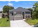 Beautiful two-story home with a three-car garage, well manicured lawn and beautiful landscaping at 9223 Brindlewood Dr, Odessa, FL 33556