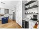 Kitchen with island, wine cooler, and a beverage center with open shelving at 9223 Brindlewood Dr, Odessa, FL 33556