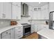 Bright kitchen boasts stainless appliances, white cabinetry, and modern finishes at 9223 Brindlewood Dr, Odessa, FL 33556