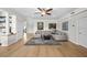 Open-concept living room featuring hardwood floors, a sectional couch, and stylish decor at 9223 Brindlewood Dr, Odessa, FL 33556
