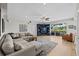 Spacious living room with hardwood floors, a large sectional, and a custom built in entertainment center at 9223 Brindlewood Dr, Odessa, FL 33556