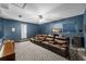 Spacious media room with seating, entertainment center, and stylish decor at 9223 Brindlewood Dr, Odessa, FL 33556