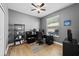 Office boasts hardwood floors, a ceiling fan, and ample natural light at 9223 Brindlewood Dr, Odessa, FL 33556