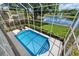 Enclosed pool offers private fun and a lovely view of the lake at 9223 Brindlewood Dr, Odessa, FL 33556