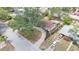 Charming single-story home featuring a lovely brick driveway, mature trees, and a well-maintained landscape at 9810 N 53Rd St, Temple Terrace, FL 33617