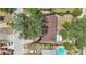 Aerial view of home with pool, carport, and mature trees surrounding property at 9810 N 53Rd St, Temple Terrace, FL 33617