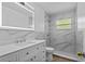 Modern bathroom features white vanity with marble countertops and tiled shower at 9810 N 53Rd St, Temple Terrace, FL 33617