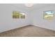 Bright bedroom features tile floors and two windows offering natural light at 9810 N 53Rd St, Temple Terrace, FL 33617