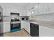 Bright kitchen with white cabinets, stainless steel appliances, and stylish countertops at 9810 N 53Rd St, Temple Terrace, FL 33617
