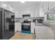 Well-lit kitchen with ample cabinet space, modern appliances, and tile backsplash at 9810 N 53Rd St, Temple Terrace, FL 33617