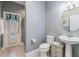 Charming powder room with pedestal sink, complemented by a window to pool view with lovely patterned fabric valance at 10313 Scarlet Chase Dr, Riverview, FL 33569