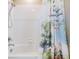Bathtub and showerhead combination with white tiled walls and Winnie-the-Pooh themed shower curtain at 10313 Scarlet Chase Dr, Riverview, FL 33569