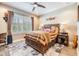 Comfortable bedroom with a bed, wooden nightstands, a ceiling fan and custom decor at 10313 Scarlet Chase Dr, Riverview, FL 33569