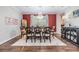 Elegant dining room featuring hardwood floors, a crystal chandelier, and bold accent wall at 10313 Scarlet Chase Dr, Riverview, FL 33569