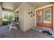 Cozy front porch with double doors, welcome mat and seating area at 10313 Scarlet Chase Dr, Riverview, FL 33569