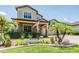 Charming home featuring an American flag, lush landscaping, and brick driveway at 10313 Scarlet Chase Dr, Riverview, FL 33569