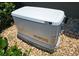 Guardian 26kW Generator unit outside on gravel bed with foliage and brick trim at 10313 Scarlet Chase Dr, Riverview, FL 33569