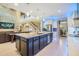 Spacious open kitchen boasts a large island, modern stainless appliances, and stylish pendant lighting at 10313 Scarlet Chase Dr, Riverview, FL 33569