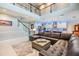 Spacious living room featuring a large leather sofa and an open concept layout at 10313 Scarlet Chase Dr, Riverview, FL 33569