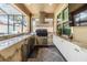 Outdoor kitchen with stainless steel appliances, marble countertops, and a covered seating area at 10313 Scarlet Chase Dr, Riverview, FL 33569