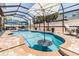 Screened-in pool with umbrella, brick coping, and an outdoor seating area at 10313 Scarlet Chase Dr, Riverview, FL 33569
