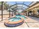 Screened-in pool with integrated spa, brick coping, and an outdoor seating area with a bar at 10313 Scarlet Chase Dr, Riverview, FL 33569