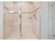 Contemporary shower boasts clear glass doors, tile surround with built-in seating and a rainfall shower head at 10313 Scarlet Chase Dr, Riverview, FL 33569