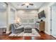Relaxing sitting room with wood floors, custom wall trim, a comfortable round chair, and a wall-mounted TV at 10313 Scarlet Chase Dr, Riverview, FL 33569