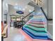Bright staircase features custom lighting, leading to the second floor and living area with comfortable seating at 10313 Scarlet Chase Dr, Riverview, FL 33569