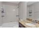 Bright bathroom featuring a shower-tub combo, tile surround, and granite vanity top at 10808 Whitecap Dr, Riverview, FL 33579