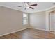 Relaxing bedroom with wood-look floors, crown molding, and a ceiling fan at 10808 Whitecap Dr, Riverview, FL 33579