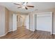 Large bedroom with wood-look floors, adjacent closets, and access to other areas of the home at 10808 Whitecap Dr, Riverview, FL 33579