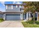 Charming two-story home boasts a beautiful blue exterior, attached garage and well kept lawn at 10808 Whitecap Dr, Riverview, FL 33579