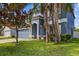 The blue exterior of this home is complemented by lush landscaping and a two-car garage at 10808 Whitecap Dr, Riverview, FL 33579