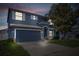 Inviting two-story home featuring an attached two-car garage, manicured lawn, and mature trees at 10808 Whitecap Dr, Riverview, FL 33579