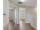 Open hallway with wood-look floors leading to various rooms of the home at 10808 Whitecap Dr, Riverview, FL 33579