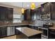 Well-equipped kitchen featuring dark cabinets, granite countertops and stainless steel appliances at 10808 Whitecap Dr, Riverview, FL 33579