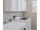 Bright laundry room with white cabinets and new washer and dryer at 10808 Whitecap Dr, Riverview, FL 33579