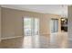 Bright living room featuring tile flooring, neutral walls, and sliding glass doors to the outside patio at 10808 Whitecap Dr, Riverview, FL 33579