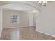 Open-concept living space with decorative tile flooring, neutral paint, window and a entry door at 10808 Whitecap Dr, Riverview, FL 33579