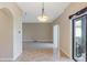 Open-concept living space with decorative tile flooring, neutral paint, view of patio and modern lighting at 10808 Whitecap Dr, Riverview, FL 33579