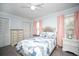Bright bedroom with a ceiling fan, plush bedding, and ample closet space at 11071 141St St, Largo, FL 33774