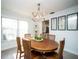 Inviting dining room features a wooden round table, elegant lighting, and neutral decor at 11071 141St St, Largo, FL 33774