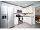 Modern kitchen featuring stainless steel appliances, granite countertops, and white cabinetry at 11071 141St St, Largo, FL 33774