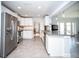 Bright kitchen with stainless steel appliances, white cabinets, and an island with granite countertops at 11071 141St St, Largo, FL 33774