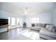 Bright living room featuring a ceiling fan and glass doors that lead to the outdoor patio at 11071 141St St, Largo, FL 33774