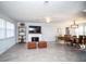 Open-concept living room with fireplace, dining area, ceiling fan, and neutral color palette at 11071 141St St, Largo, FL 33774