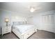 Relaxing main bedroom with a ceiling fan, plush bedding, and ample closet space at 11071 141St St, Largo, FL 33774