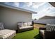 Outdoor patio area with wicker furniture and artificial grass for outdoor relaxation at 11071 141St St, Largo, FL 33774