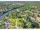 Aerial shot of the neighborhood with pond and river access amidst lush greenery at 11109 Winn Rd, Riverview, FL 33569
